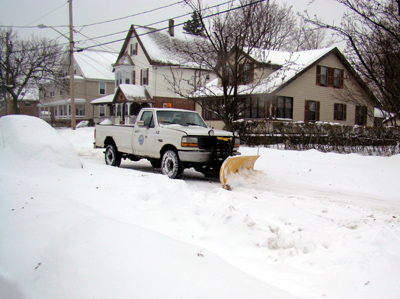 A plow works on Dudley Street during last weekâ€™s storm
