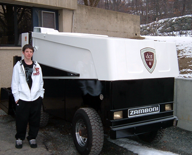 Medford Vocational student Dan Grogan stands by a Zamboni he helped work on for the state.