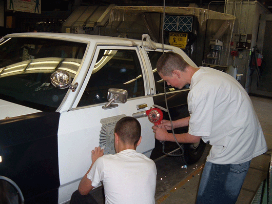 Voke students work on car